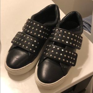 Studded black leather slip on sneakers